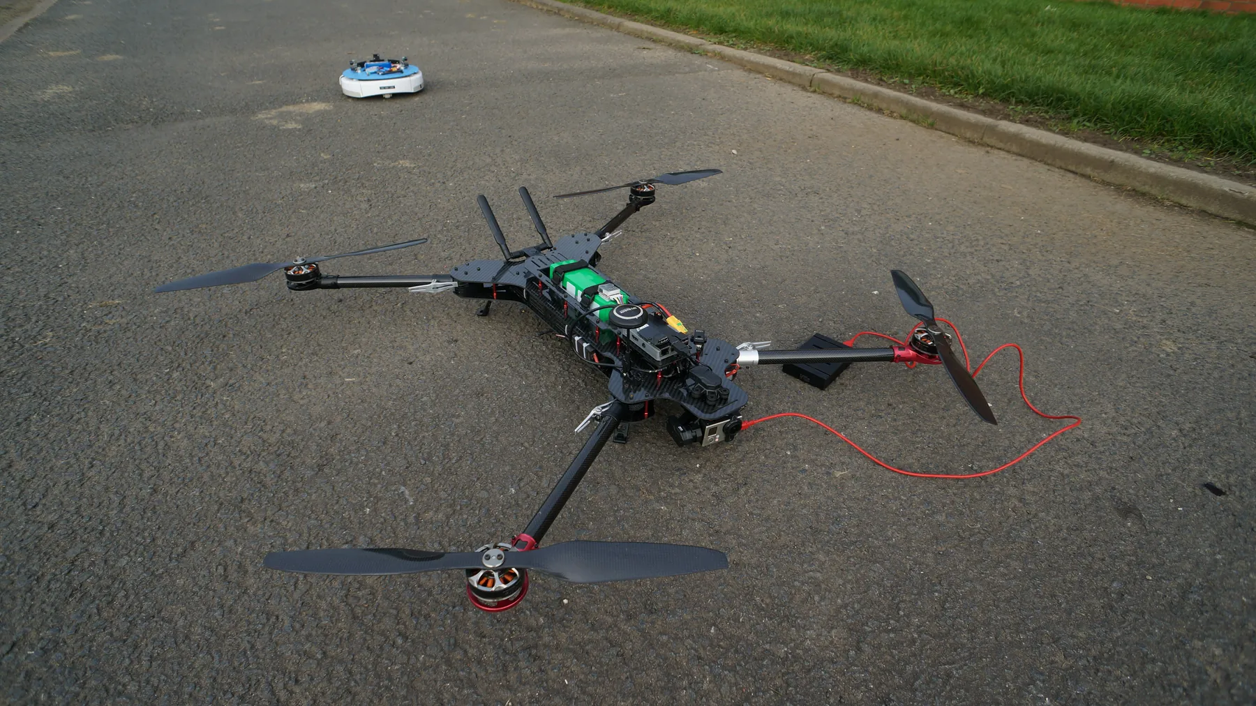 Custom-built X-frame quadcopter on a floor during assembly