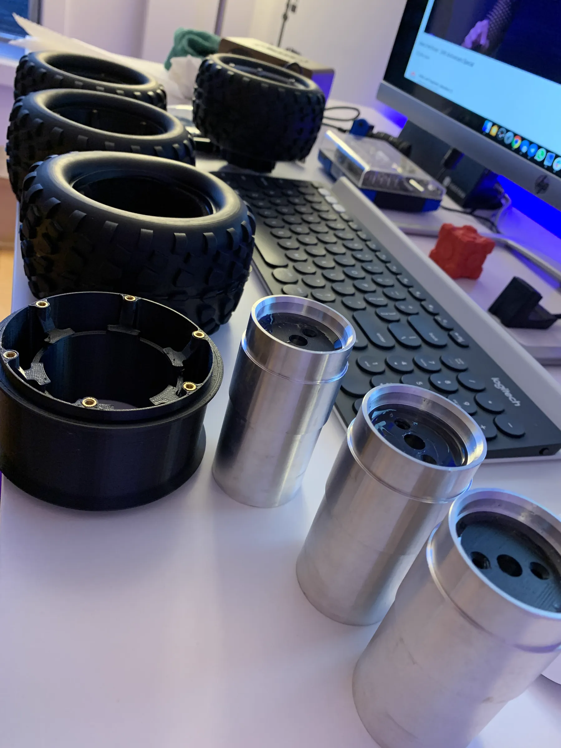 3D-printed drone ducts alongside machined aluminium parts on a desk
