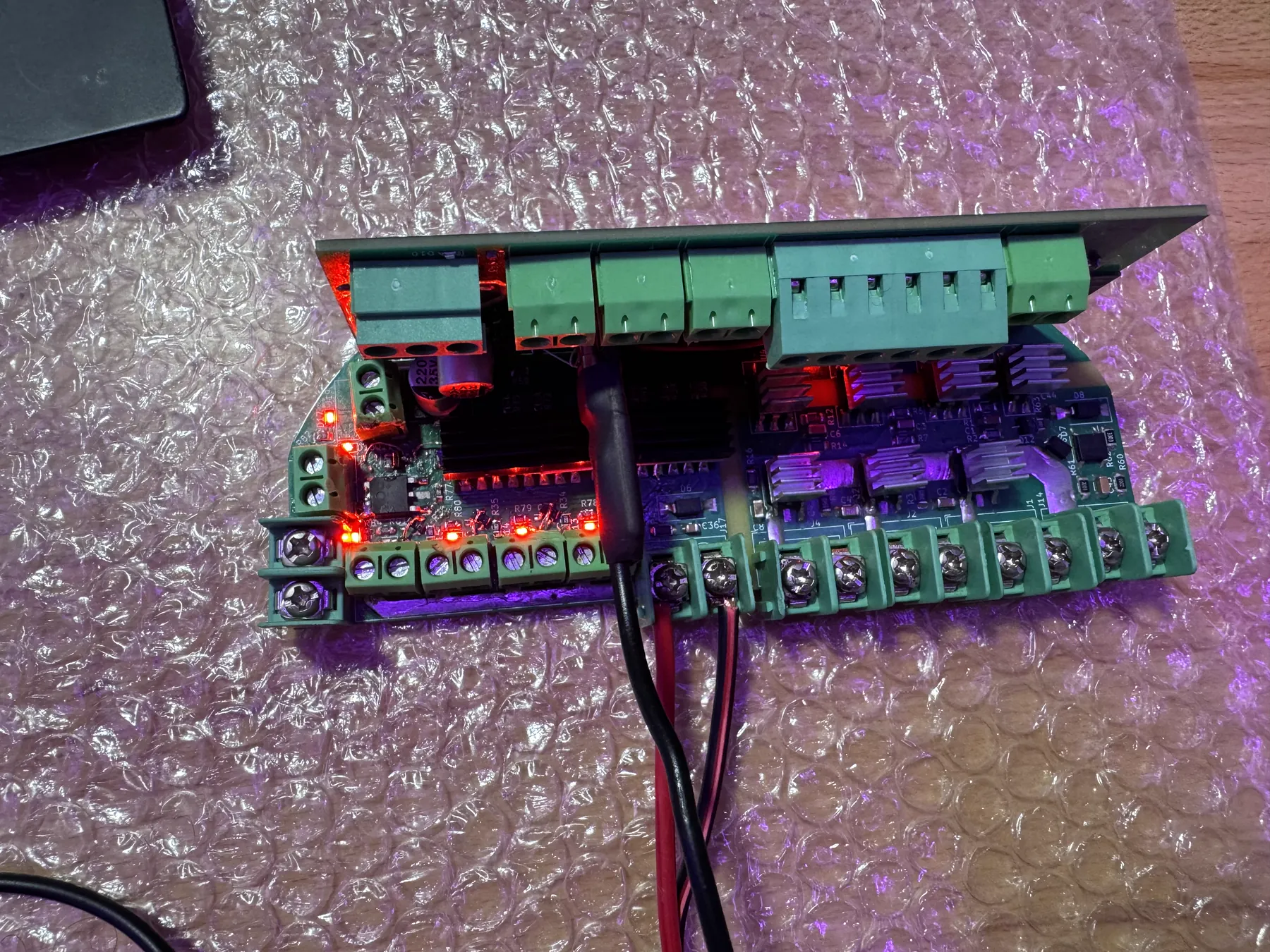 Custom power-distribution PCB with red status LEDs illuminated