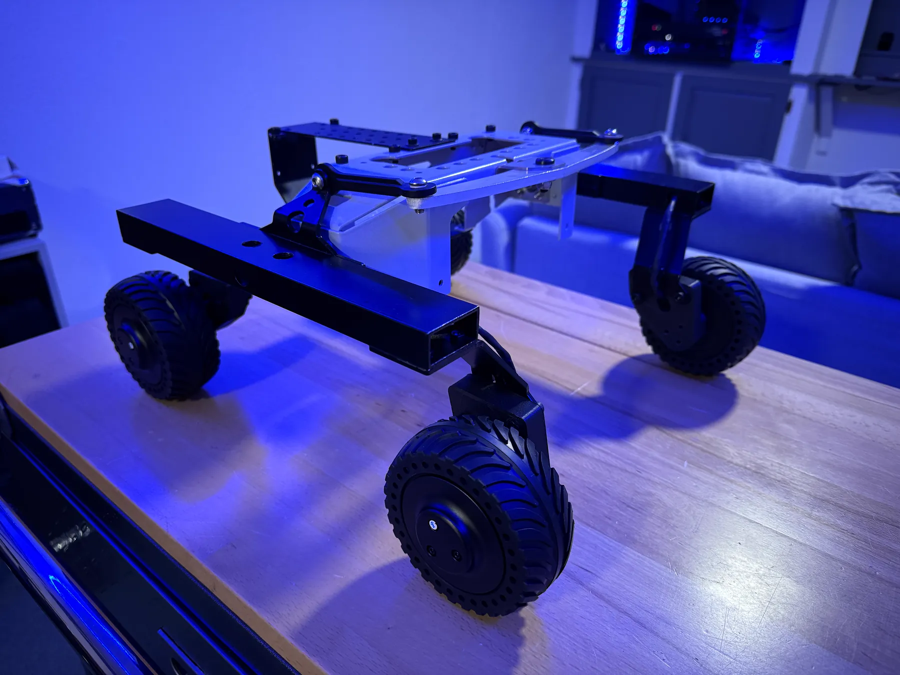 Six-wheel rover chassis photographed under blue light