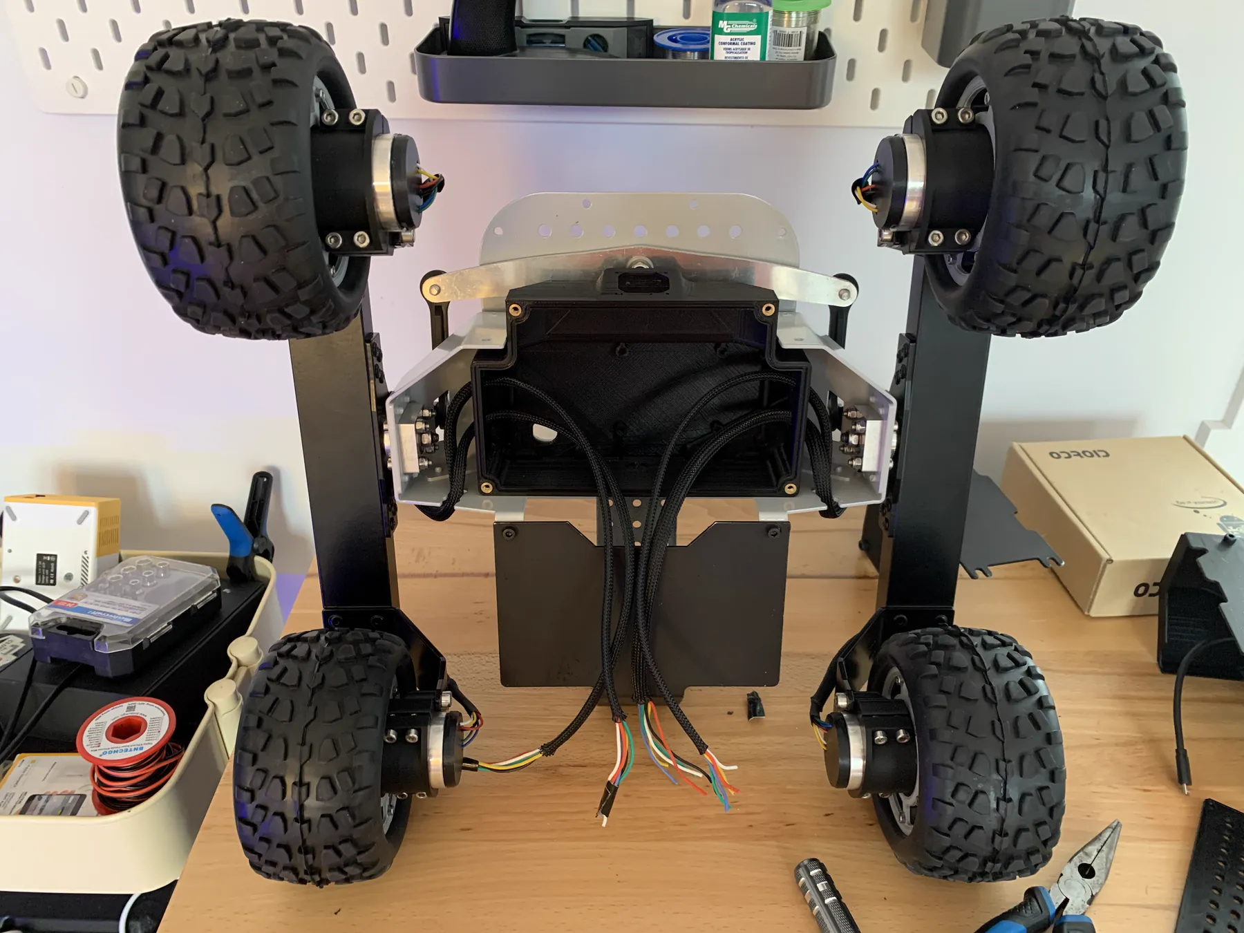 A four-wheel rover chassis being assembled on a workbench