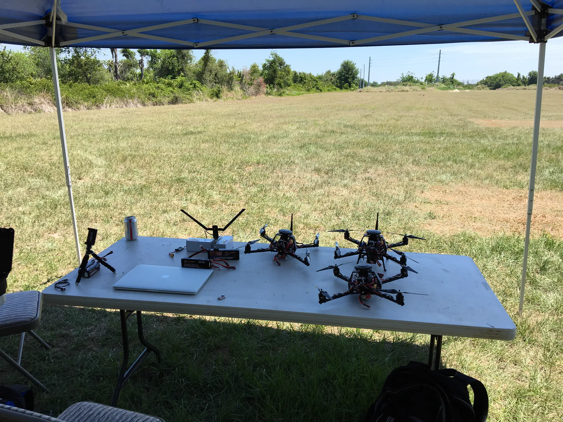 Three hexacopters lined up on a field table before a coordinated flight